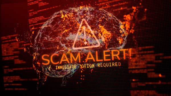 Scam Alert warning on a pixelated computer background with a faint brain outline overtop