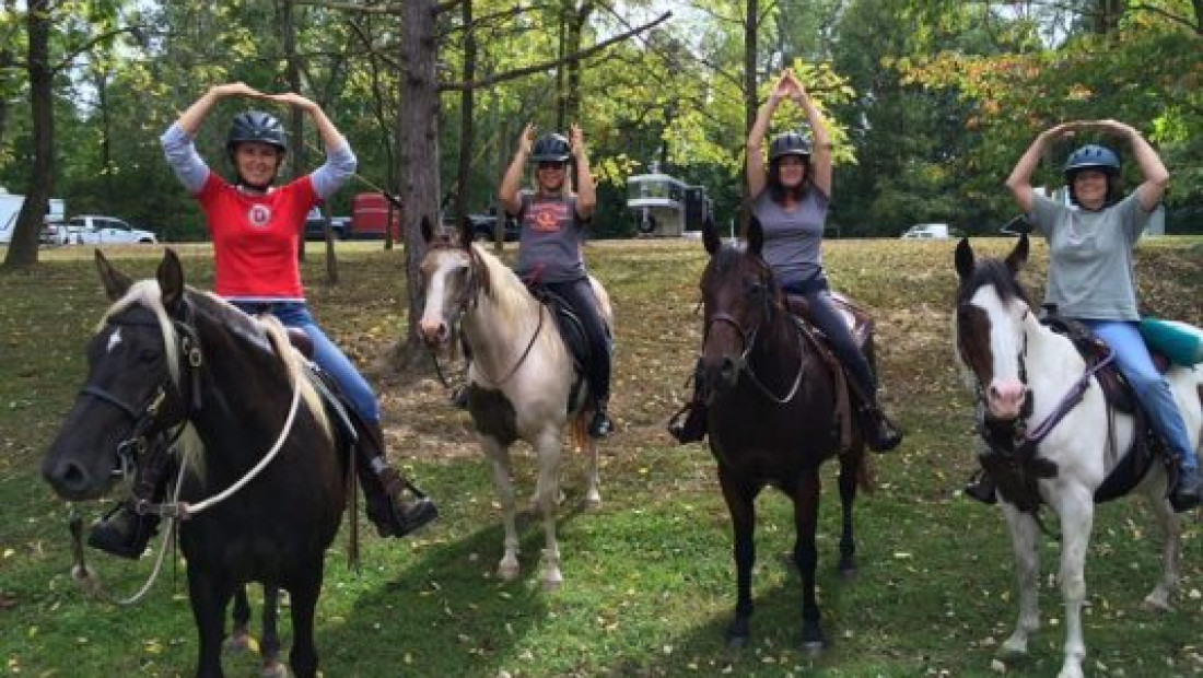 a group of people riding on the backs of horses