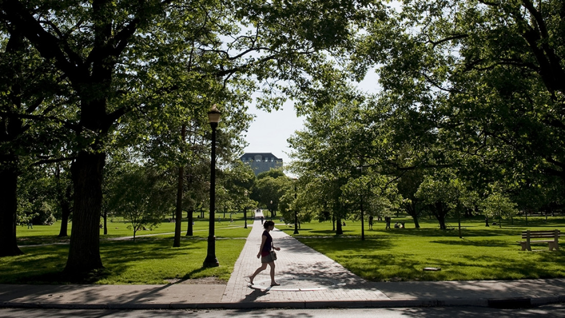 a student walking on the OSU oval
