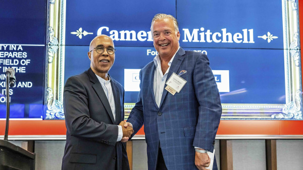 Dean Don Pope-Davis of EHE shaking hands with restaurant owner Cameron Mitchell