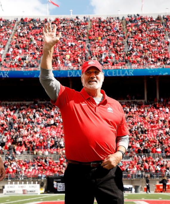 Ohio State Alumni Rick Middleton on the football field waving to a crowd