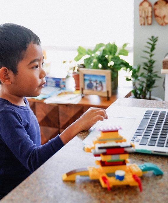 child at home on laptop