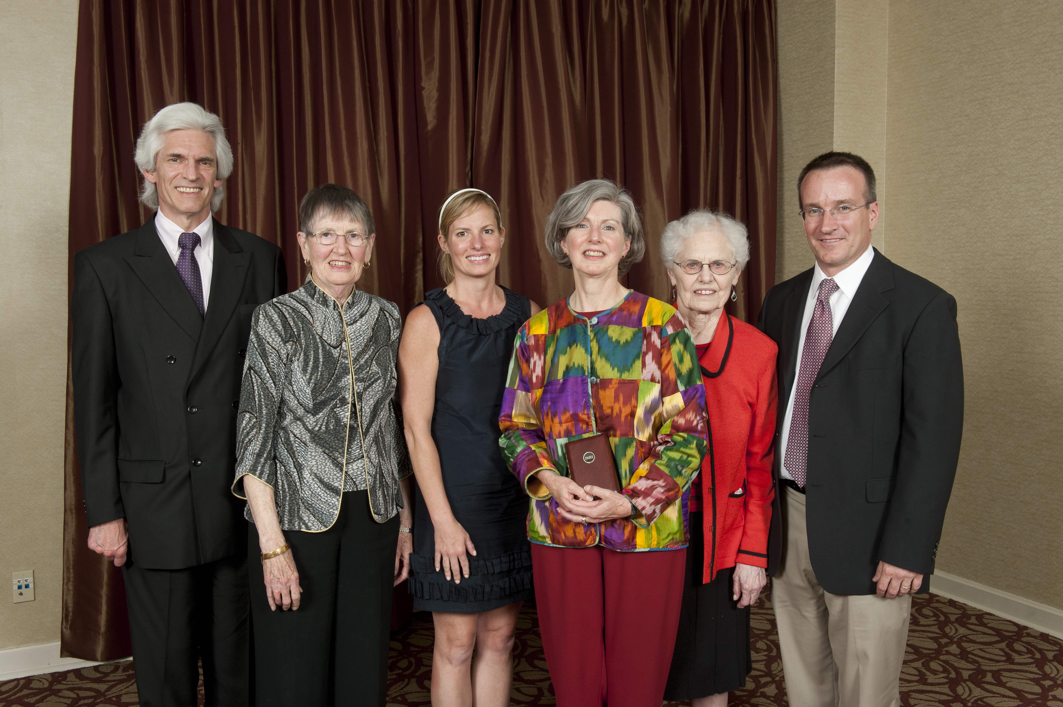 Jeanne Hogarth and family together during alumni awards ceremony