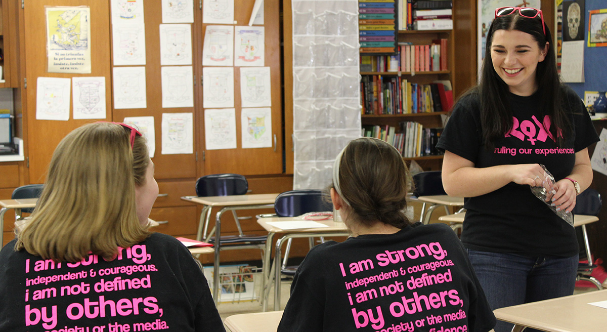 Master's student Mary Langenfeld laughs with girls attending the ROX girls' empowerment group.