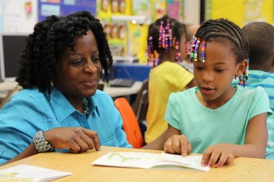 Teacher trained in Reading Recovery with first-grader in one-on-one teaching session.