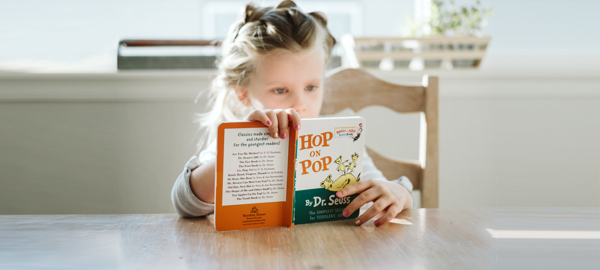 Girl reading board book