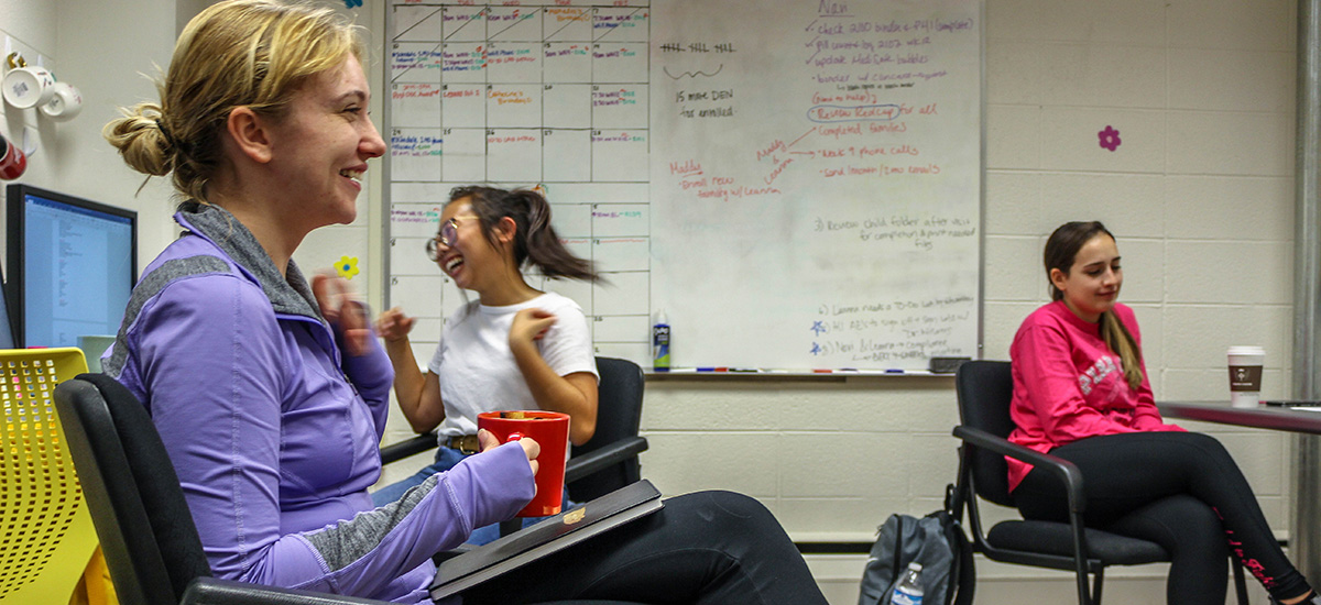 Catherine Panchyshyn, left, and Stacy Lu, center, have a light moment while working on nutrition research under the direction of Postdoctoral Researcher Leanna Perez.