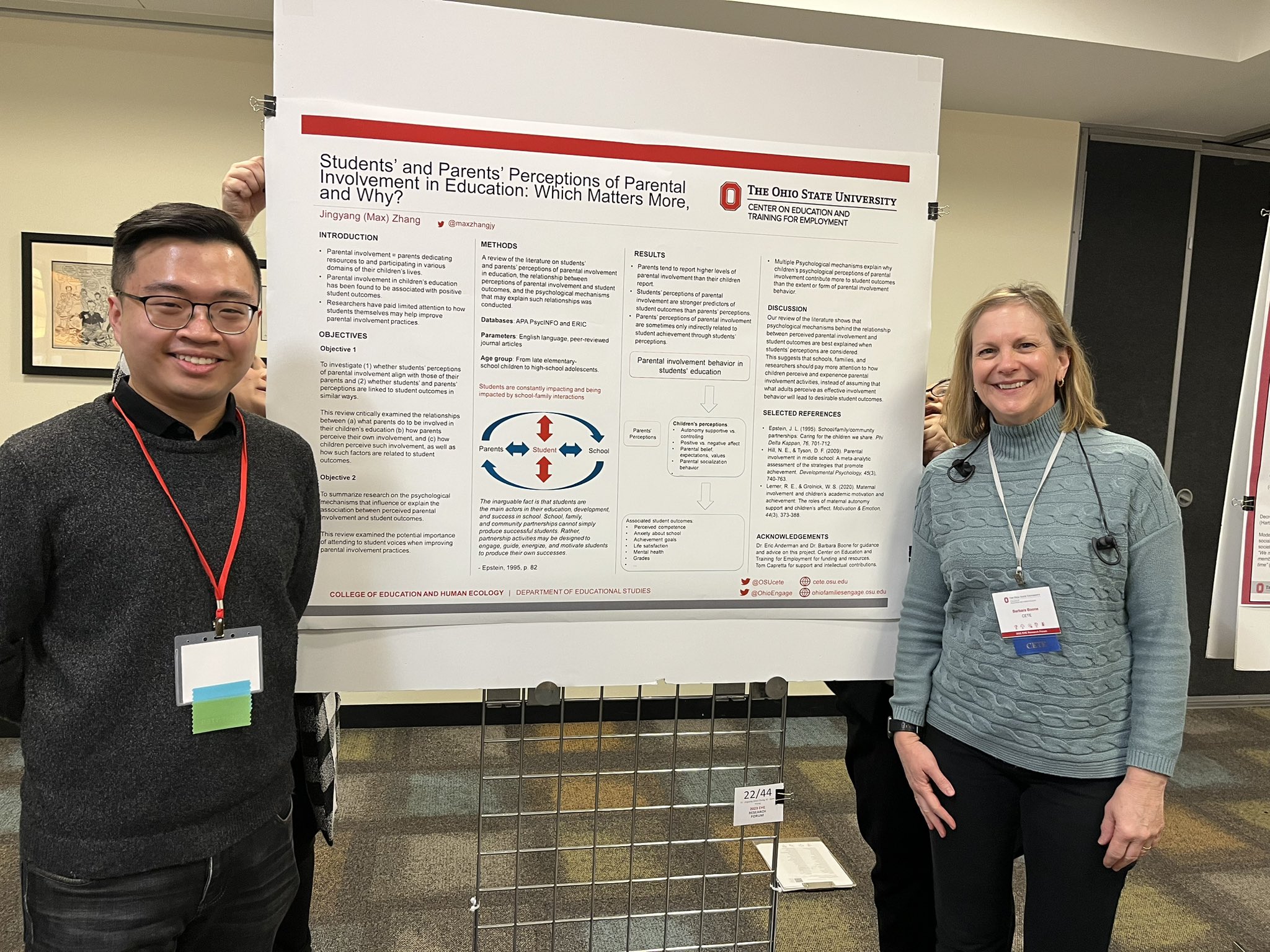 Research presenters posing with their poster at forum
