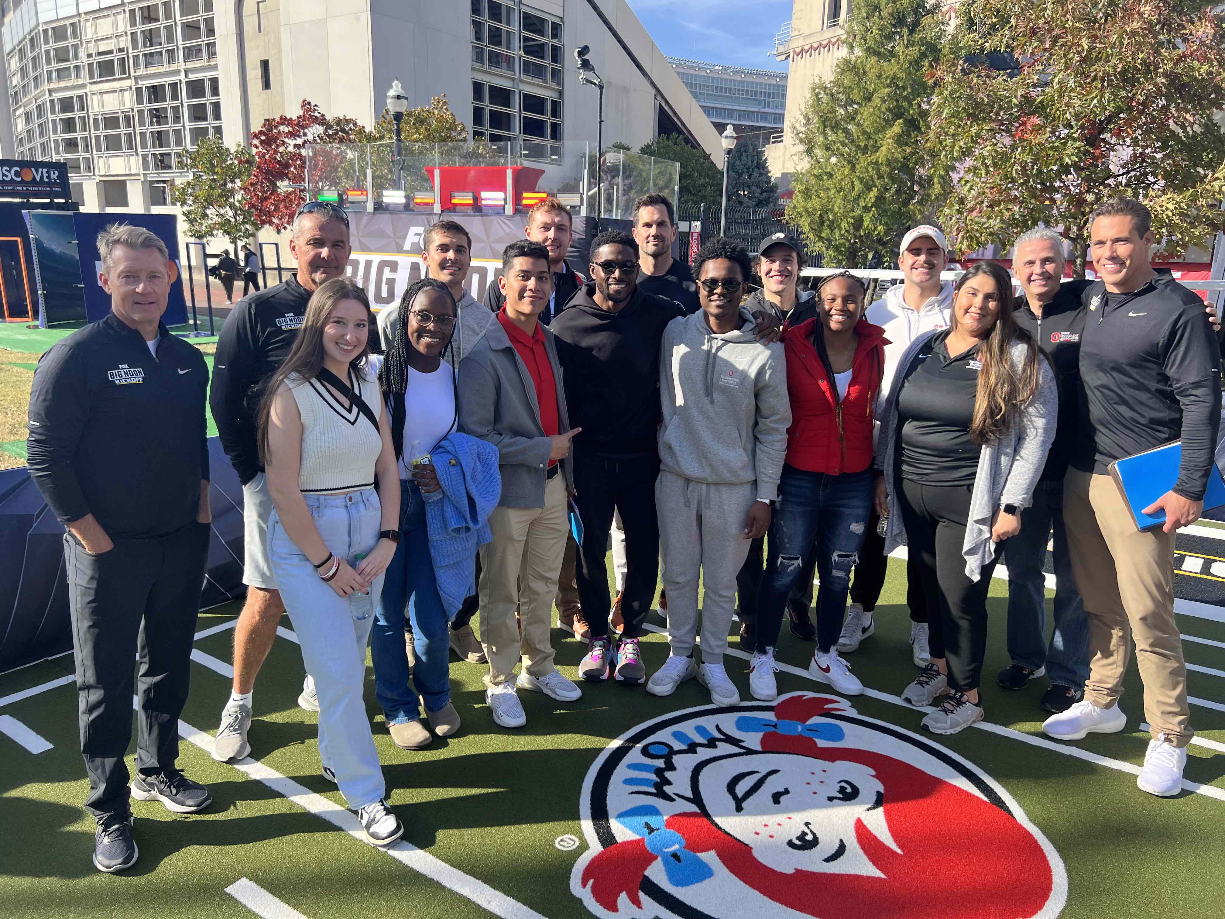 Ohio State Sport Management group posing together for a photo on a football field