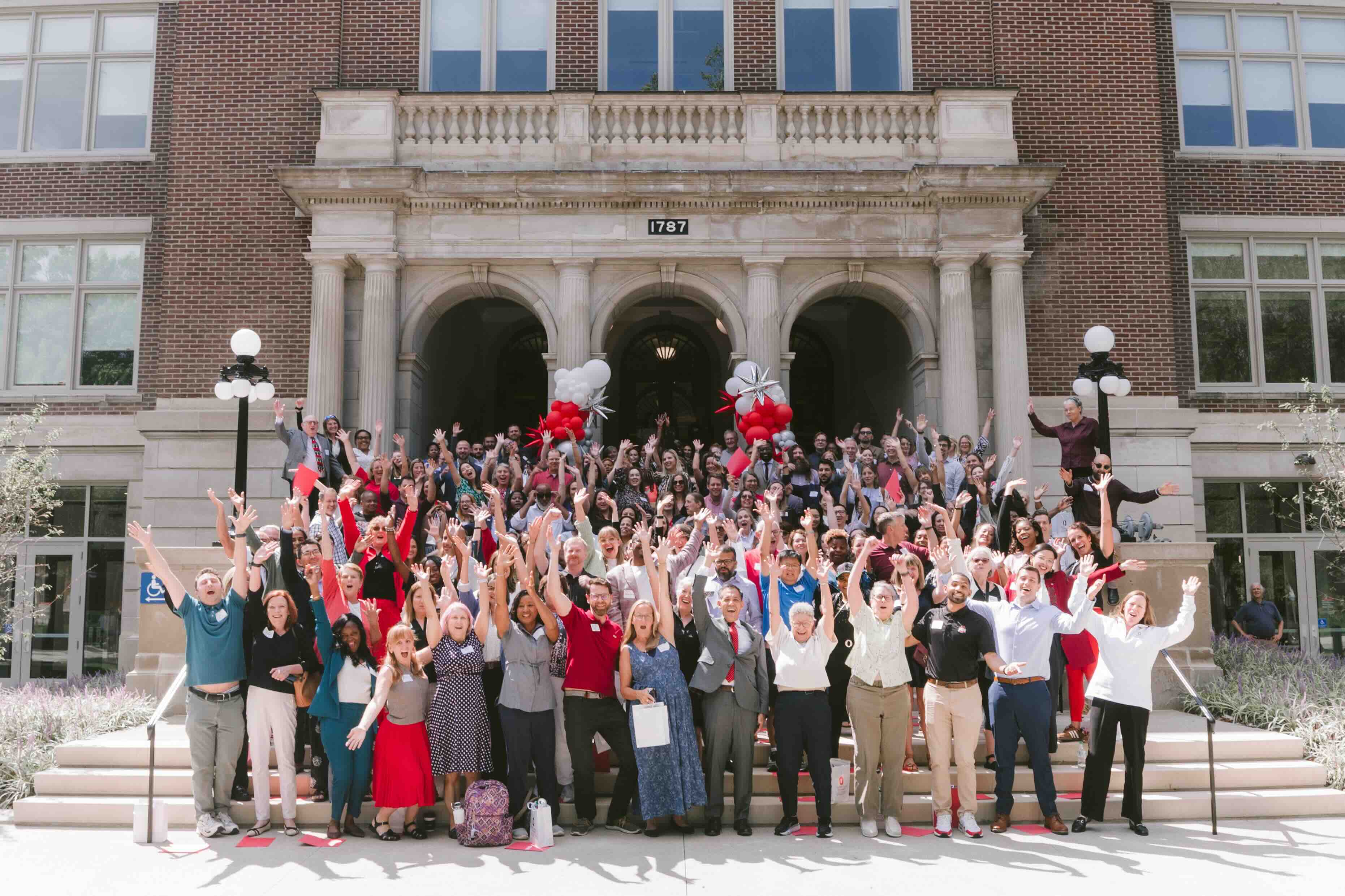 EHE facutly and staff celebrate the opening of the renovated Campbell Hall on the front steps