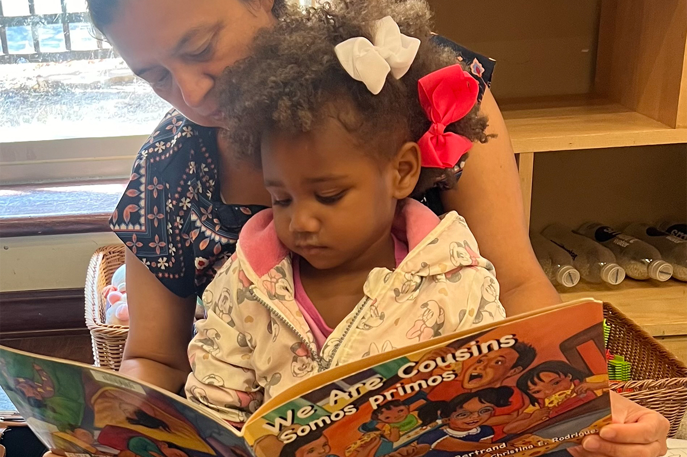 Teacher reading picture book to child