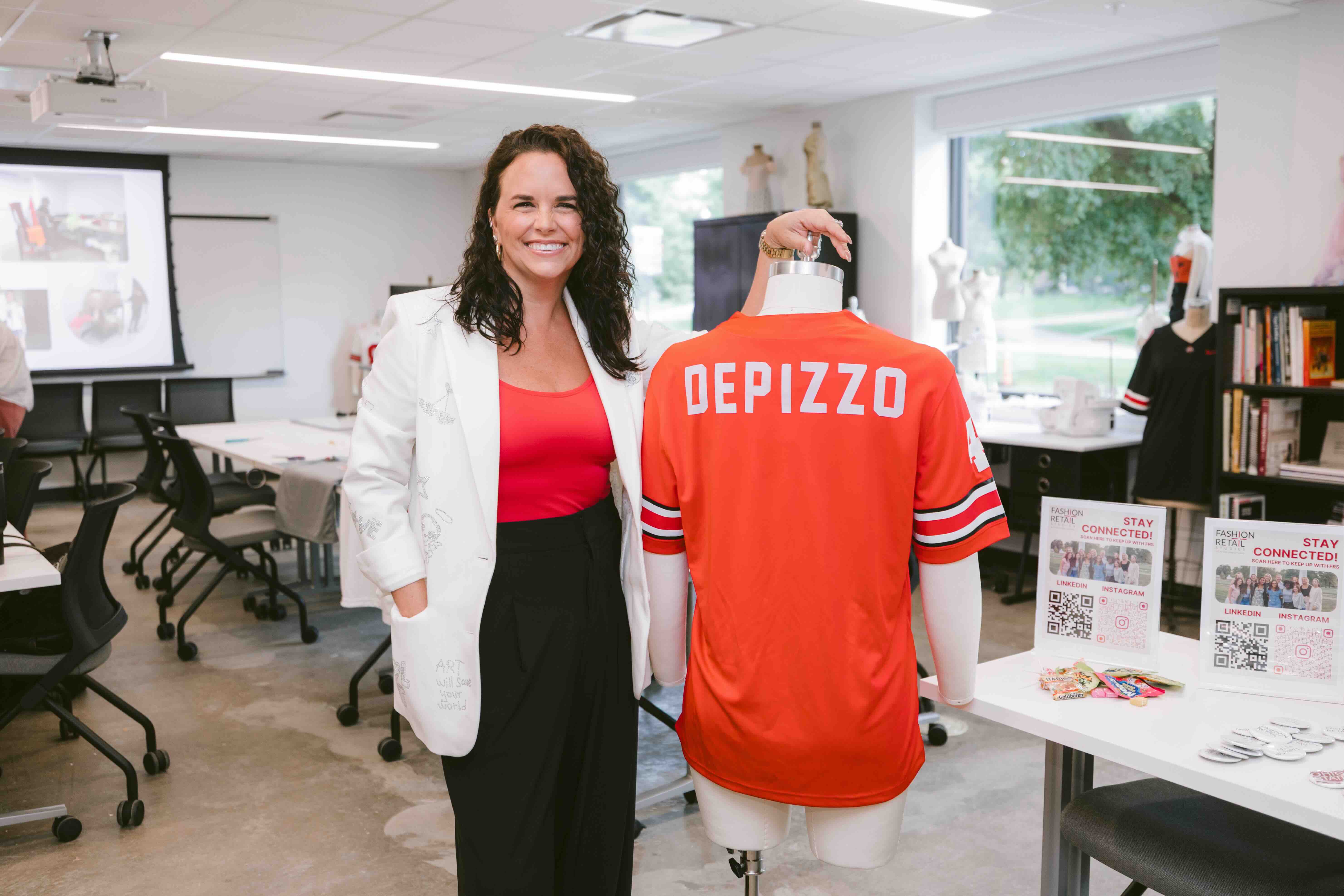 Kat DePizzo showing an Ohio State shirt in the new Fashion and Retail studies lab in Campbell Hall