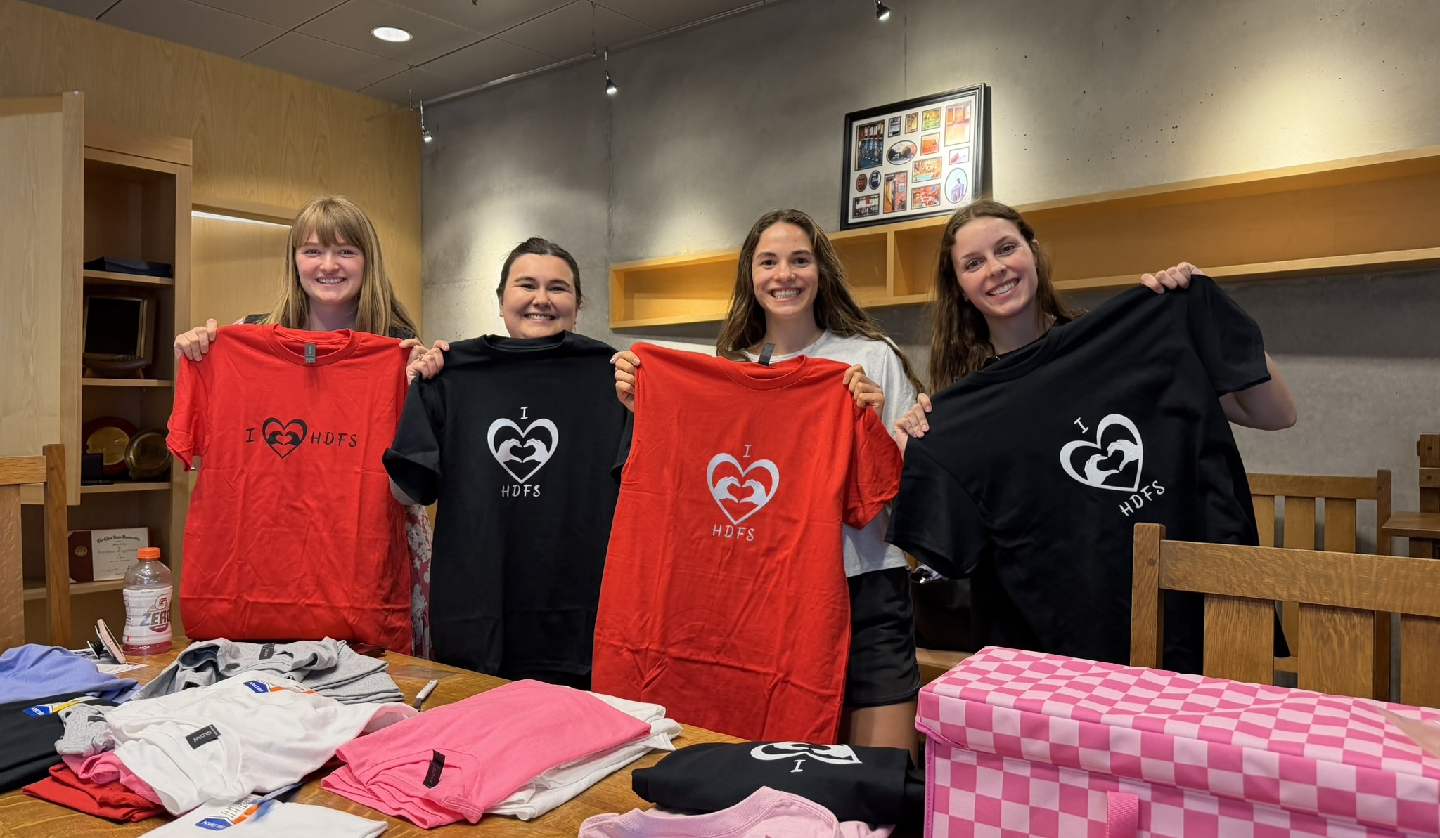 HDFS students holding up t-shirts that read "I heart HDFS"