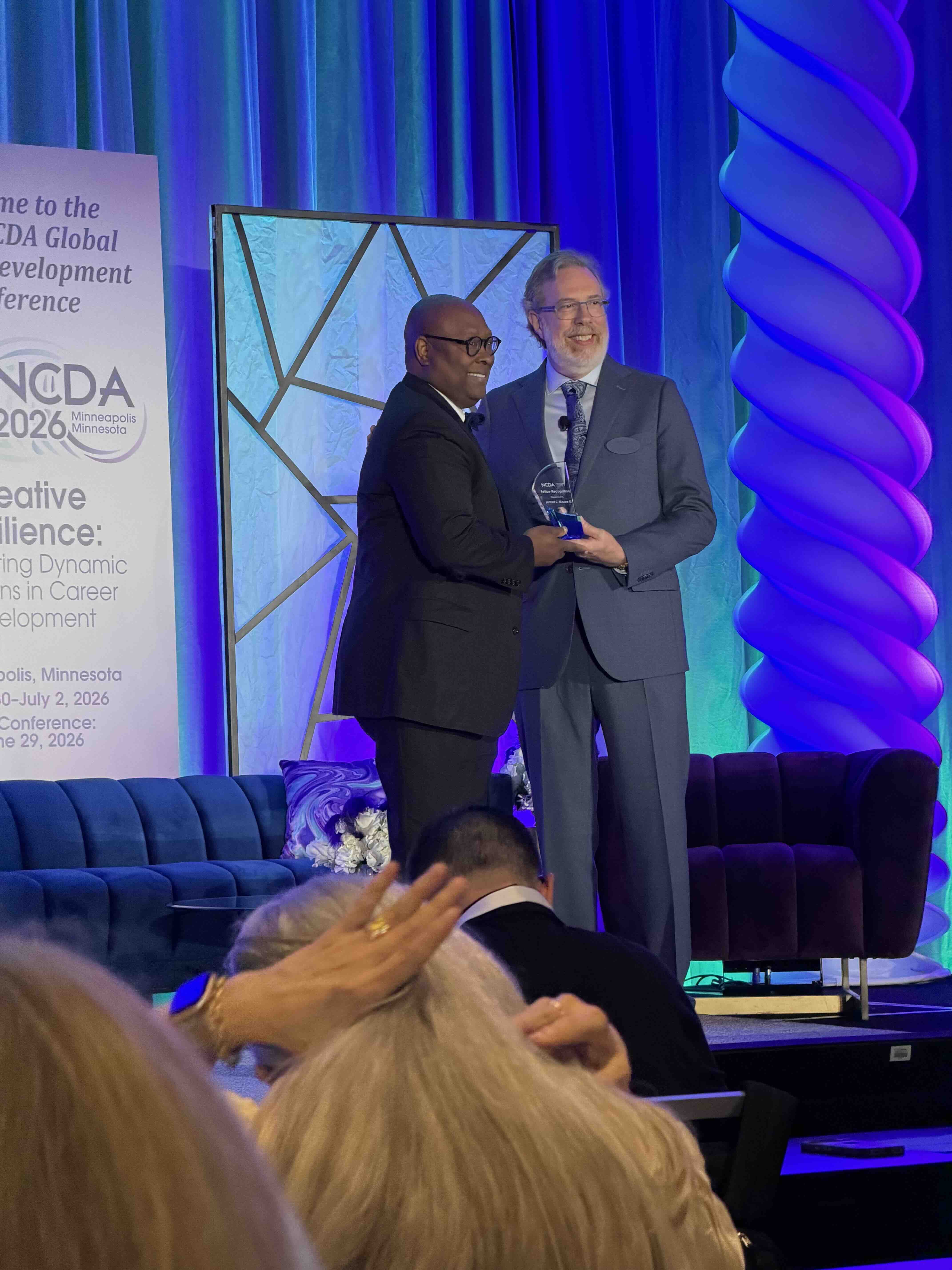 James Moore on stage receiving an award