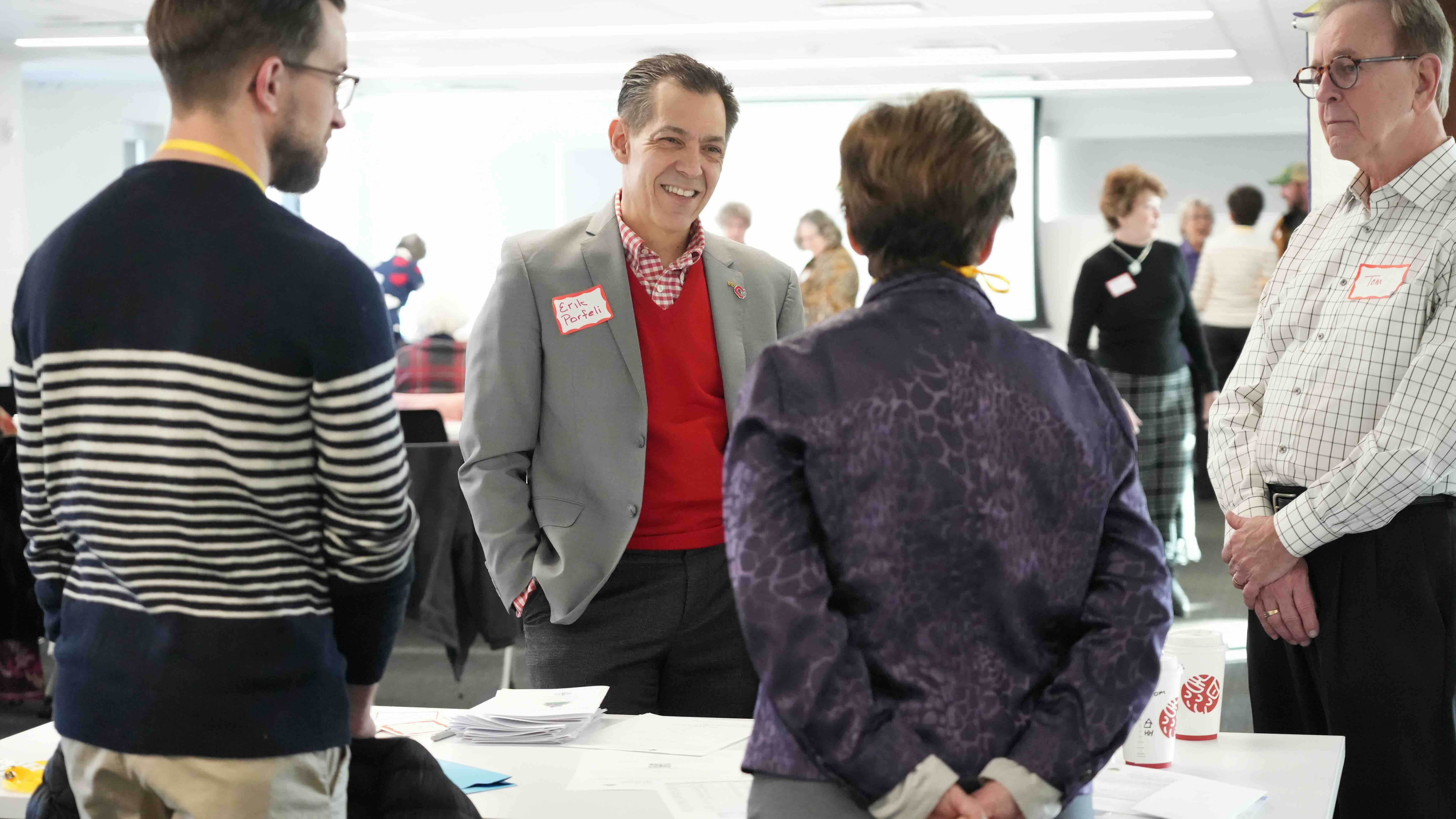 Erik Porfeli at a research event talking to participants