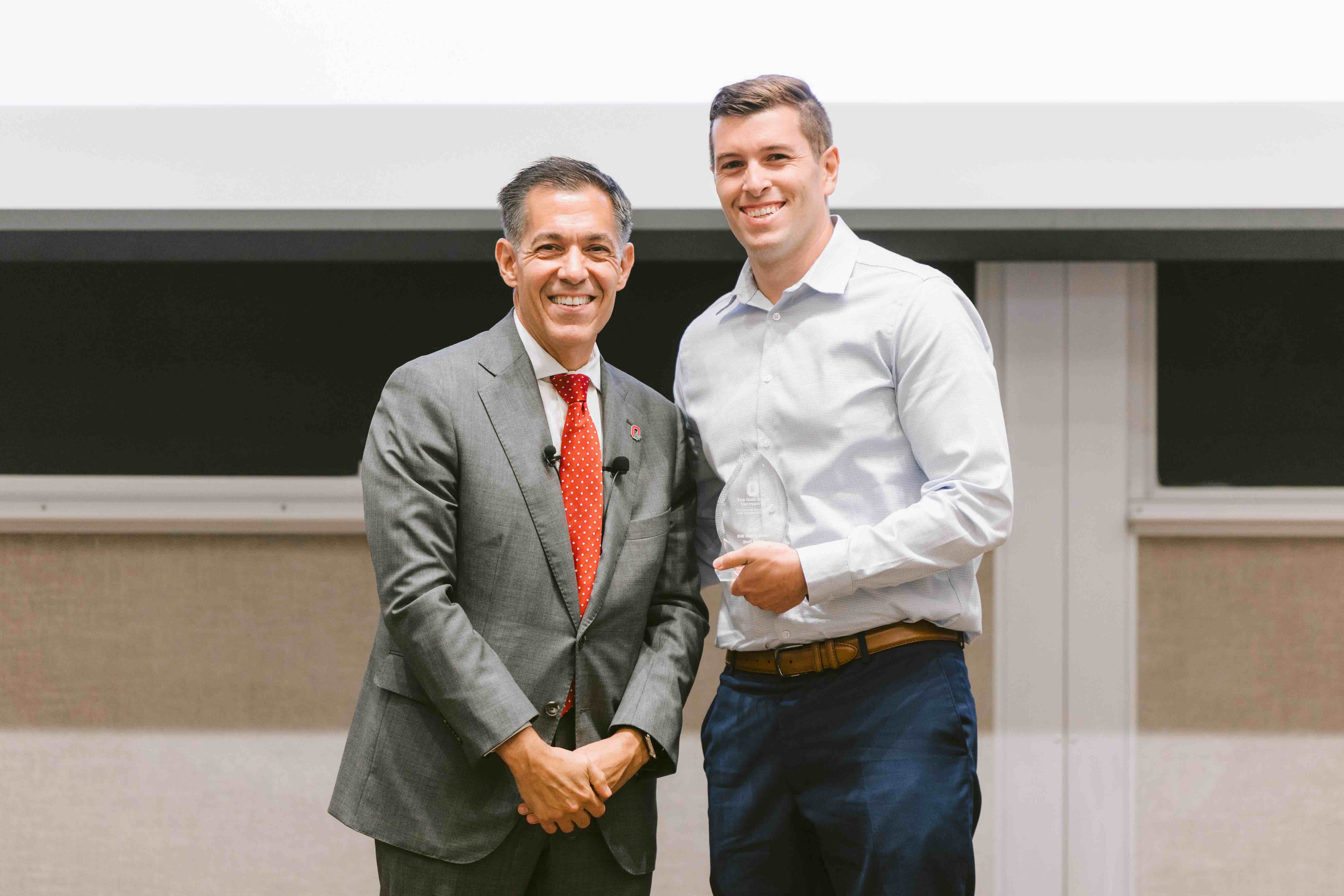 Shane Whitacre receives award from Dean Erik Porfeli