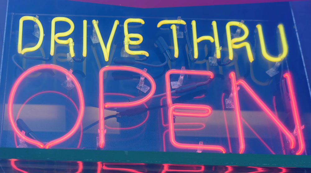Neon sign that reads drive thru open