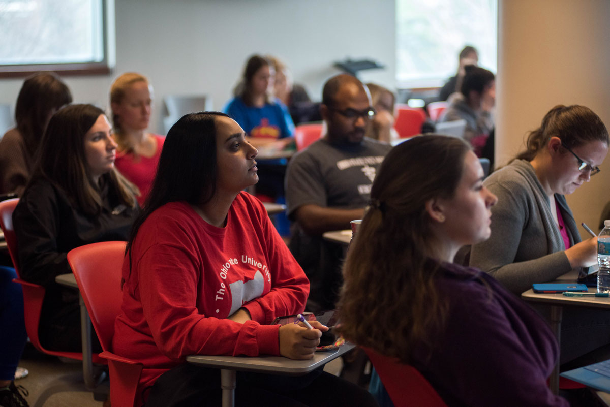 Ohio State students sit in desks listening to a lecture