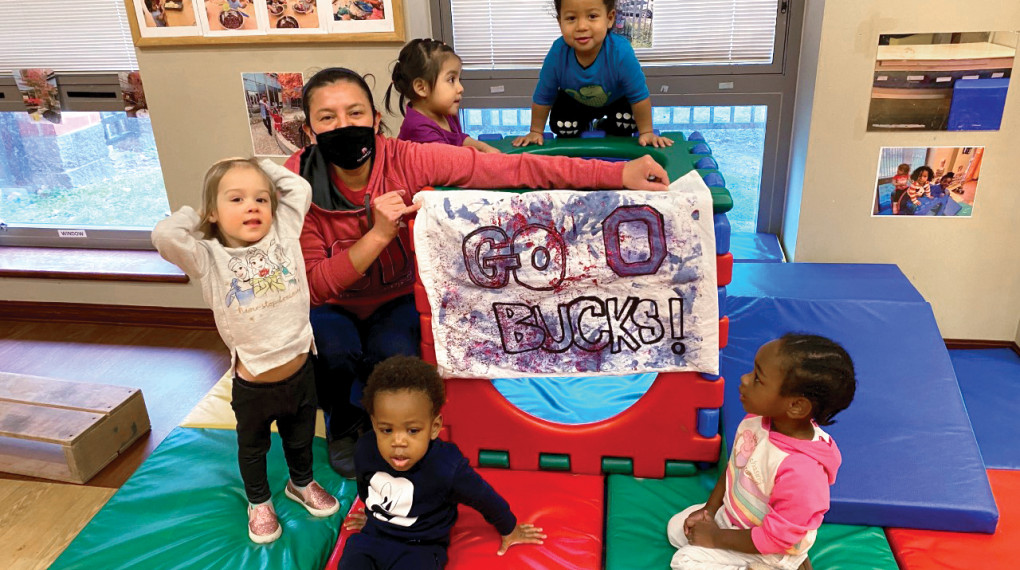 pre-school students with teacher in masks