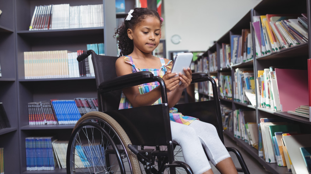 Girl in wheelchair using tablet