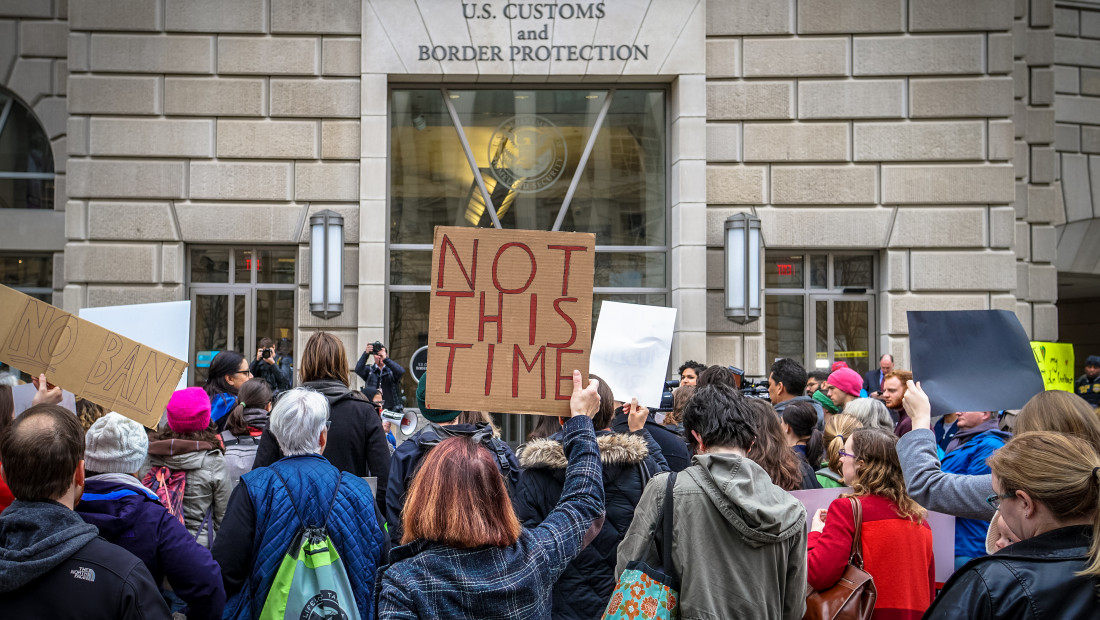 Crowd holding 'Not this time' sign