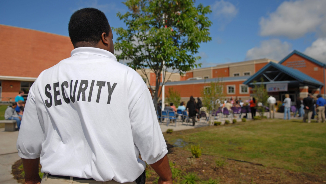 Security guard out front of a school building
