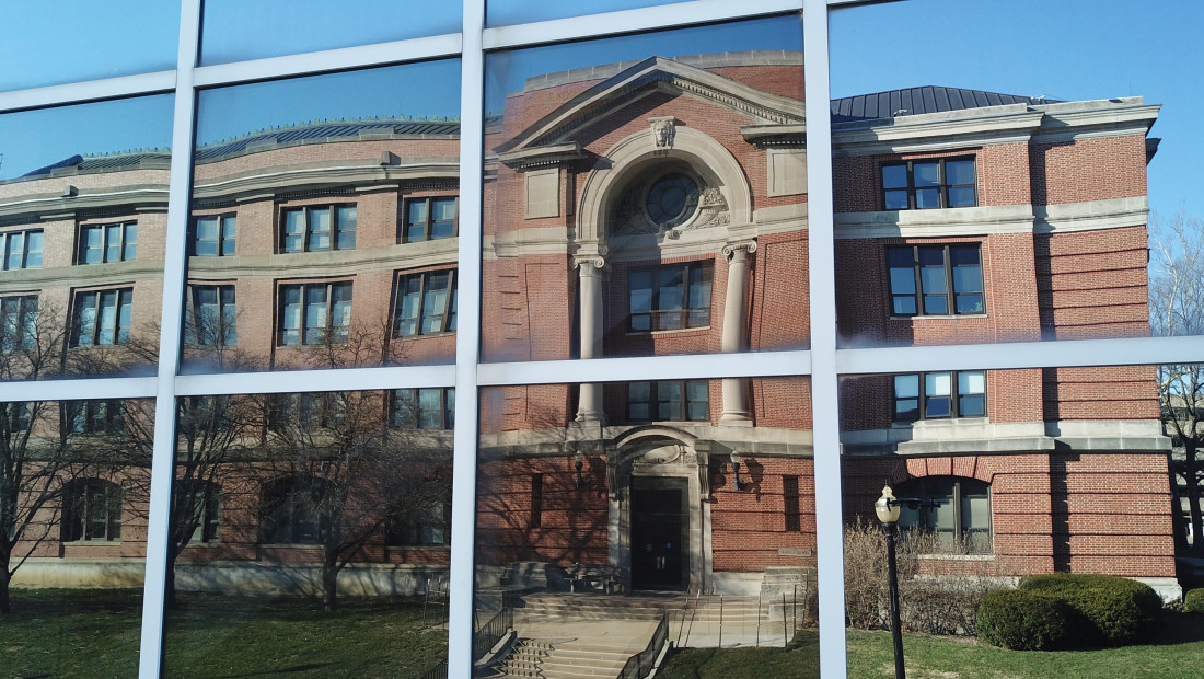 reflection of Arps hall in a pane window