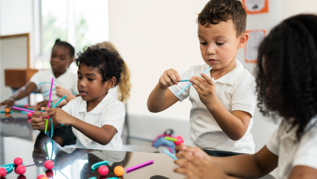 children in kindergarten classroom doing crafts