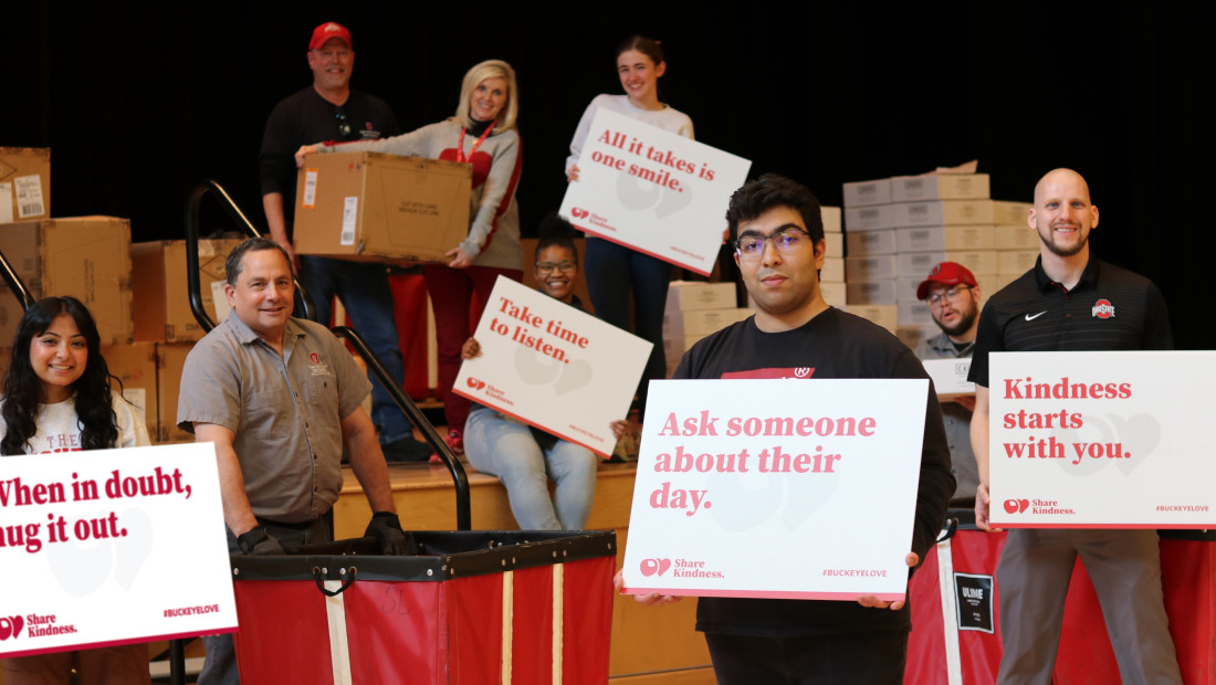 Ohio State students holding signs with words of kindness