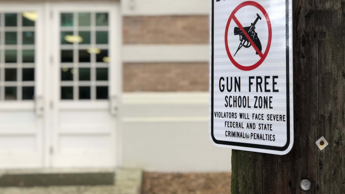 Gun Free zone sign in front of school building