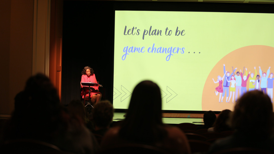 Presenter on stage giving a lecture