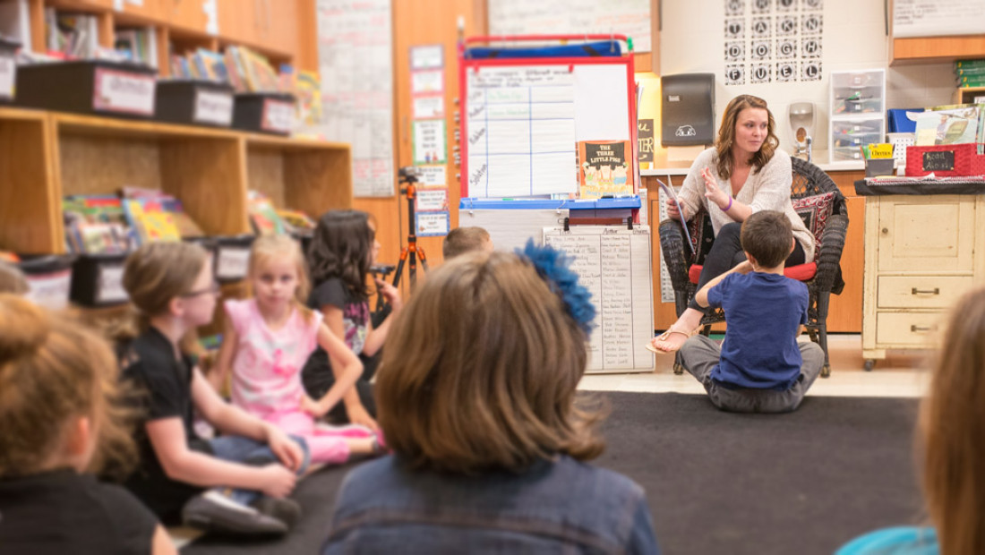 Teacher reading to students in classroom