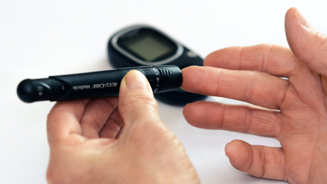 Person using finger prick to test blood sugar