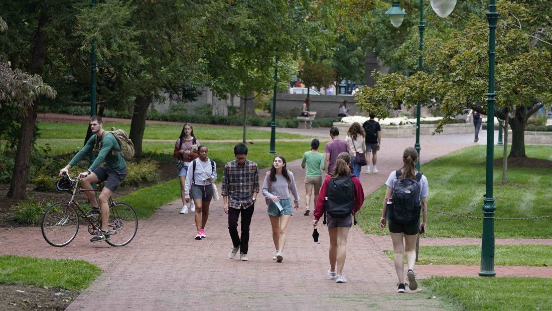 Ohio State students walking and riding bikes in the Oval