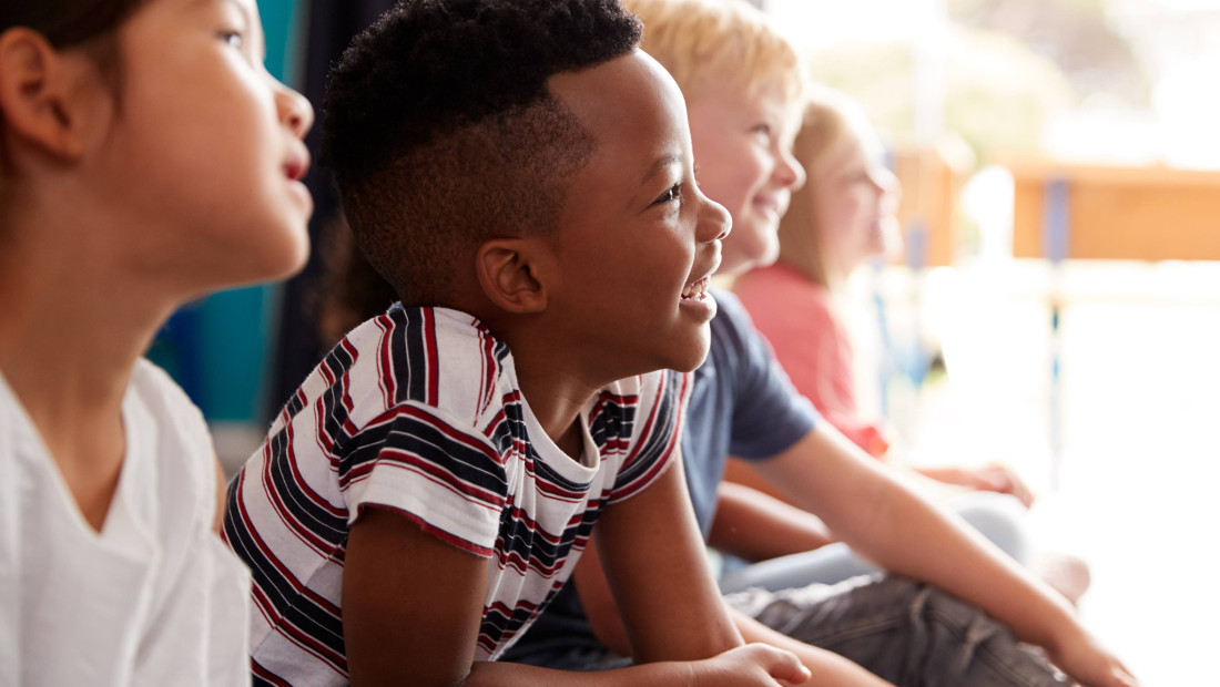 Group of elementary school students sitting on the floor