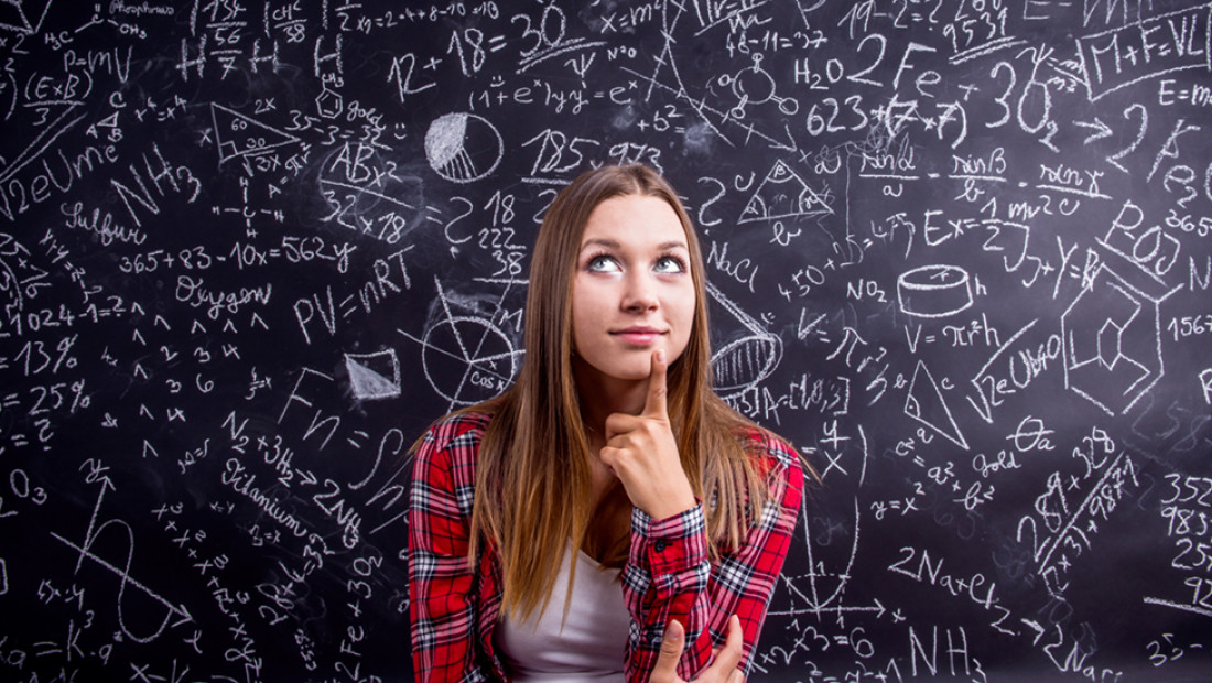 student in front of blackboard