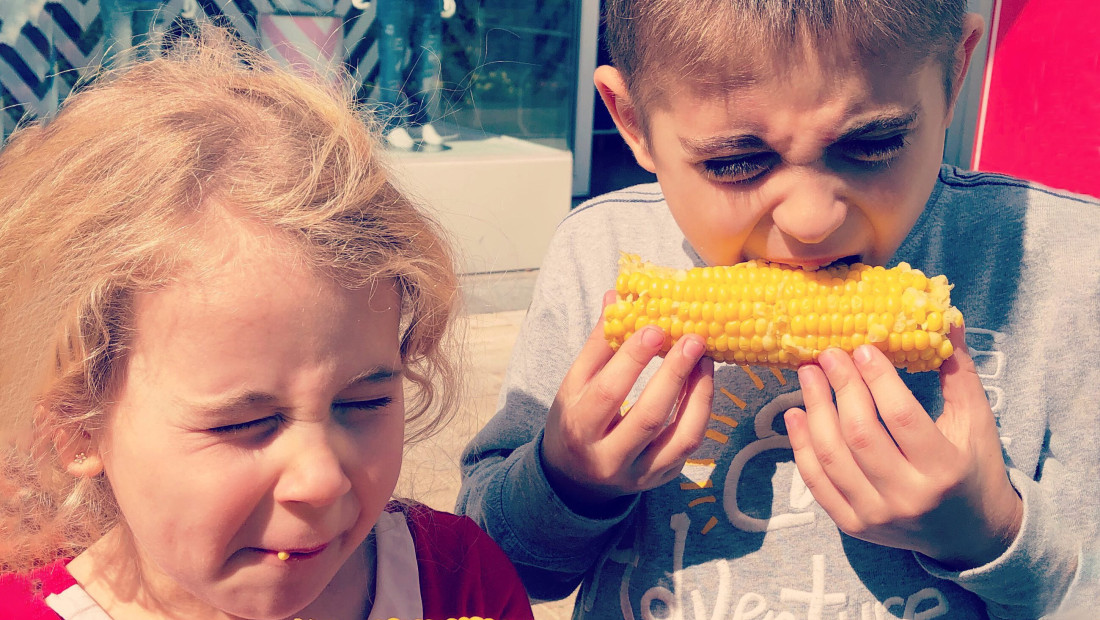 children eating ears of corn