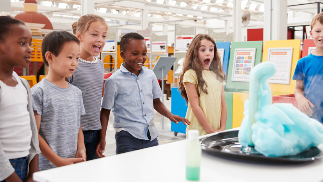 kids having fun watching science experiment