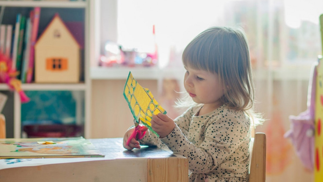 kindergarten student doing arts and crafts