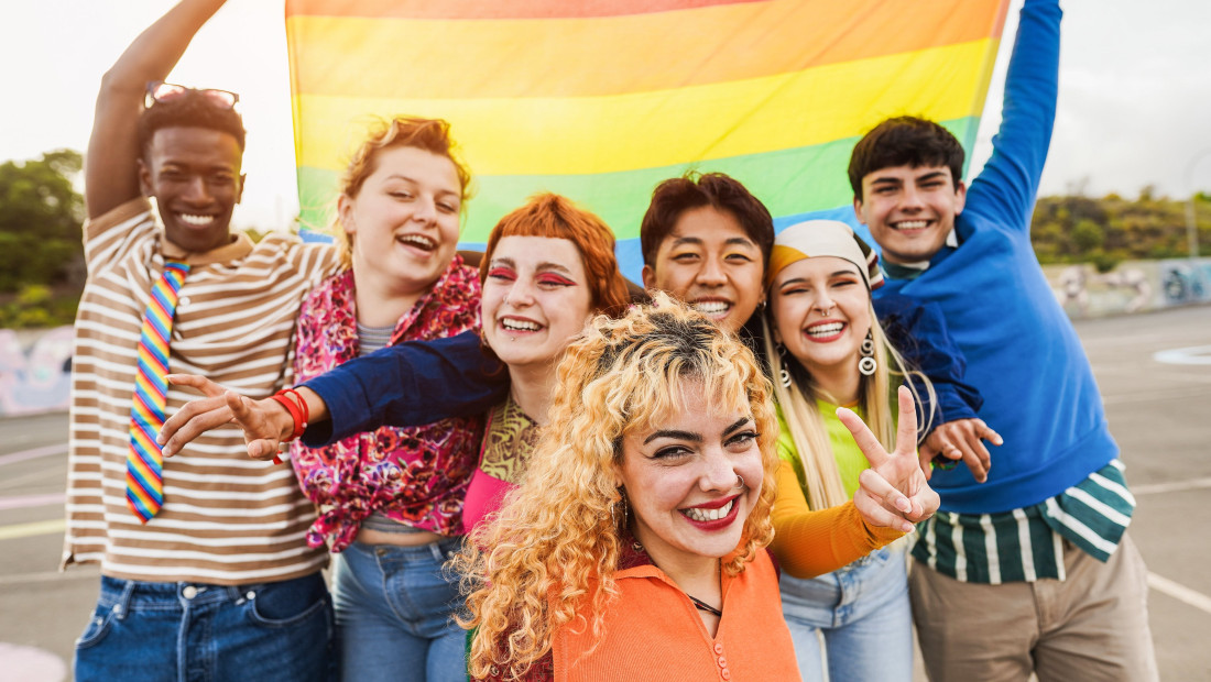 LGBTQ+ students holding a pride flag