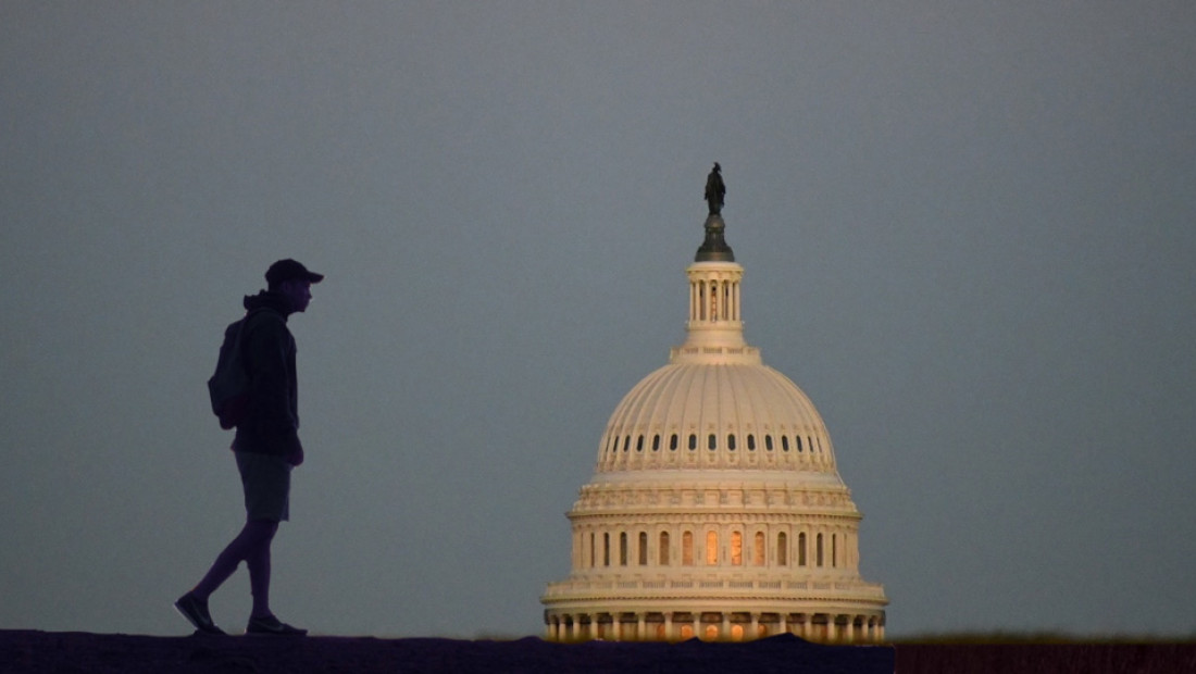 man walling by DC capitol dome