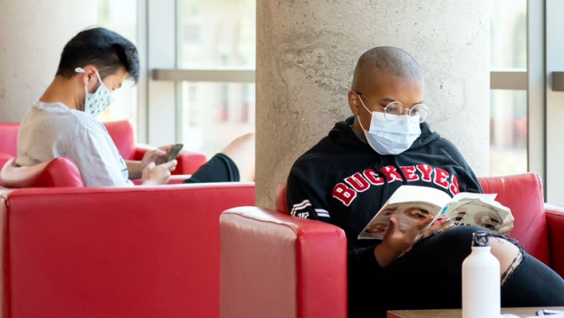 students with masks reading