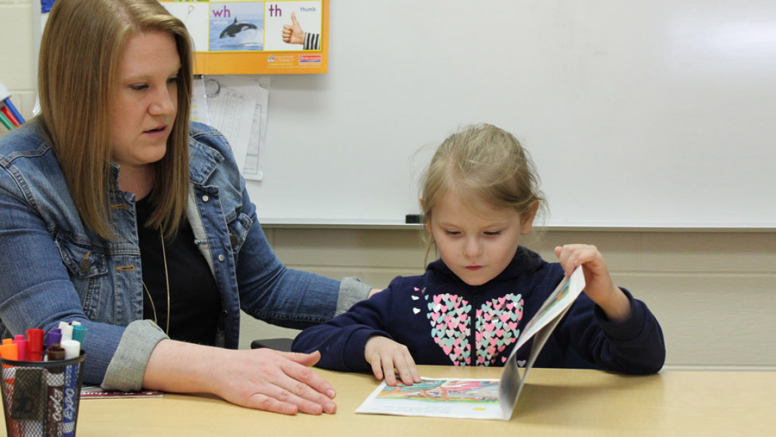 teacher working with student