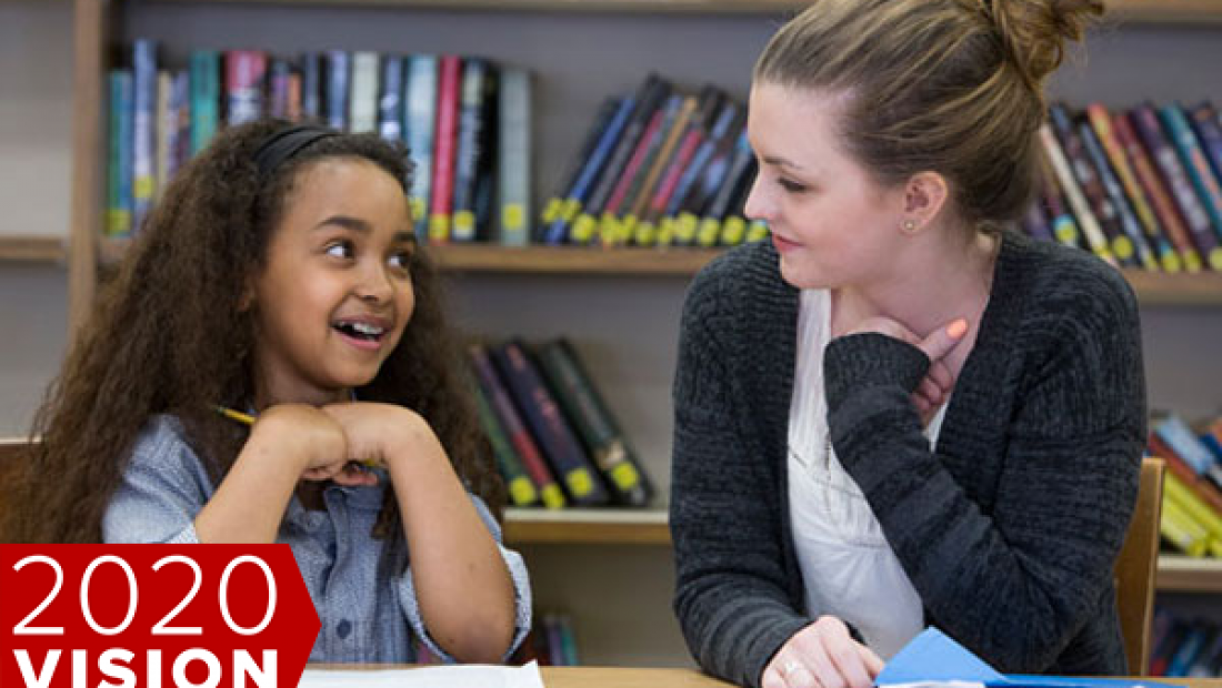 teacher with student in classroom