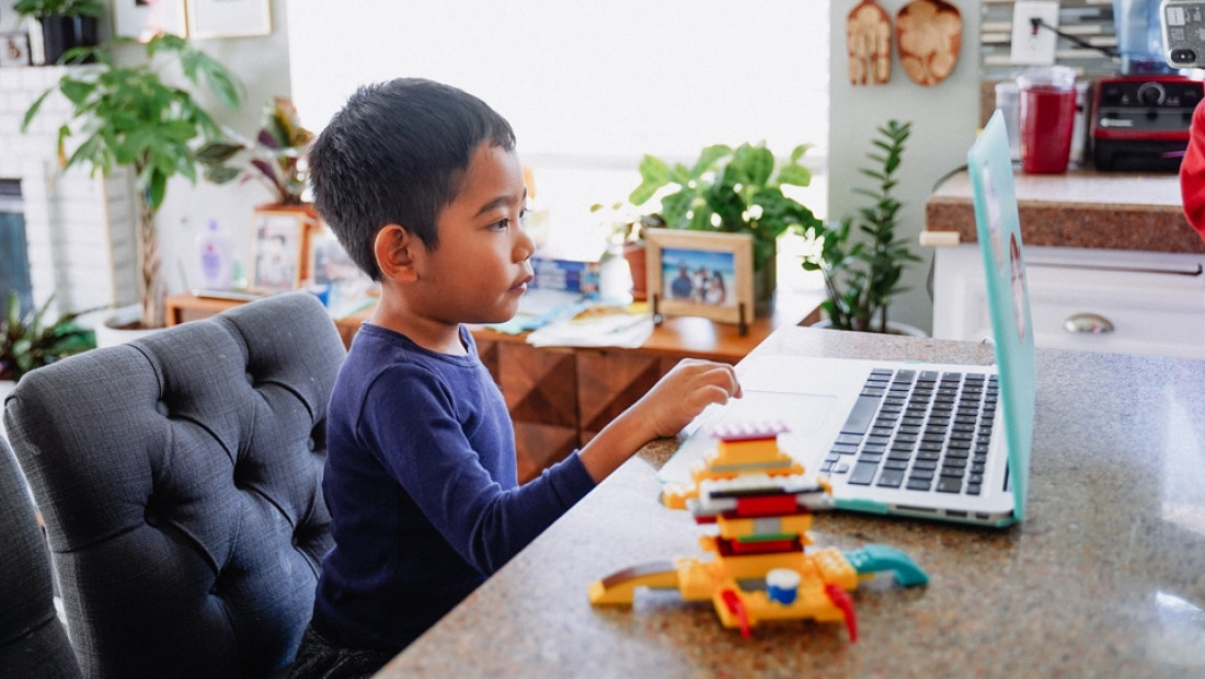child at home on laptop