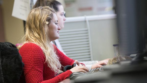 student typing on computer