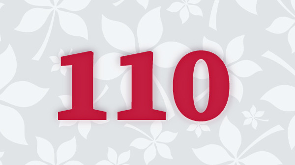The number 110 written in scarlet with buckeye leaf background
