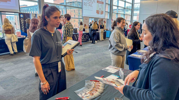 student at the FRS Career fair speaking to a representative at a table