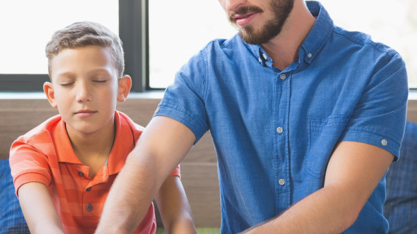 Teacher helping student read braille