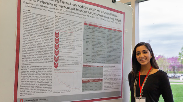 Grad student with research poster